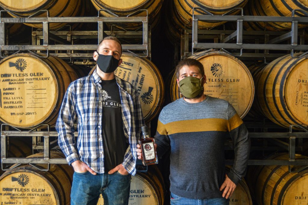 Nathan Mahinski and Max Thibodeaux posing with an exclusive-release bottle of Port-Finished Bourbon