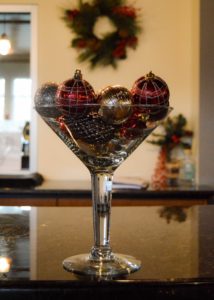 martini glass full of holiday ornaments